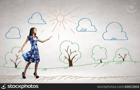 Woman in blue dress. Young woman in blue dress walking outdoors