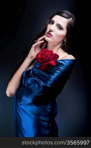 woman in blue fabric with red rose