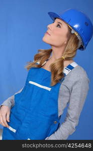 Woman in blue overalls and hardhat