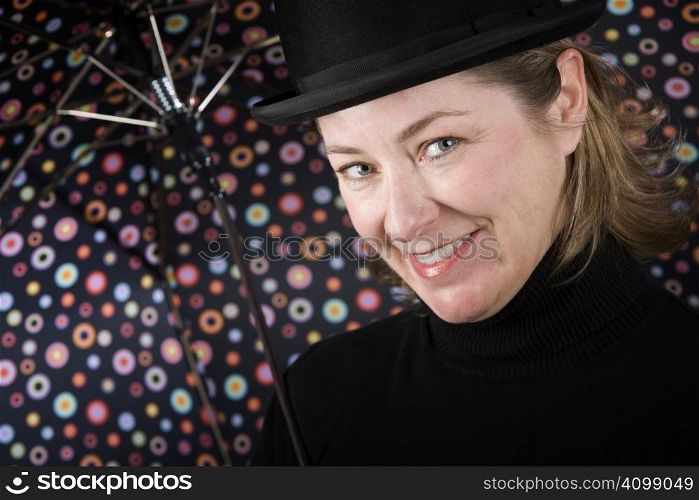 Woman in bowler hat with spotted umbrella