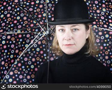 Woman in bowler hat with spotted umbrella
