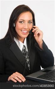 Woman in business suit smiles while working the phones at Customer Service Occupation