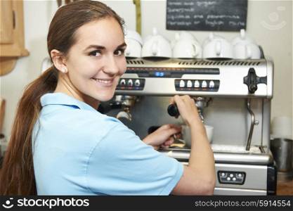 Woman In Cafe Making Cup Of Coffee