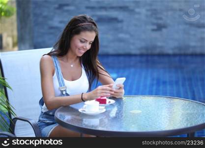 Woman in cafe with phone. Beautiful young woman in cafe with cellphone
