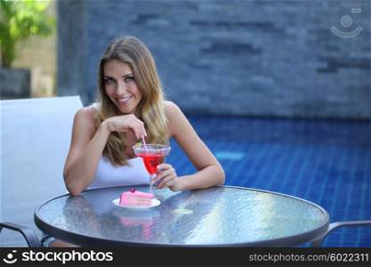 Woman in cafe. Woman with cocktail and cake in outdoor cafe