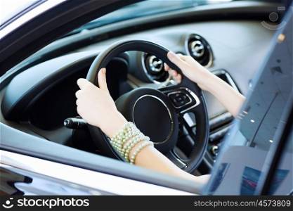 Woman in car. Close up of woman hands driving a car