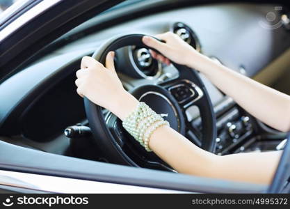 Woman in car. Close up of woman hands driving a car