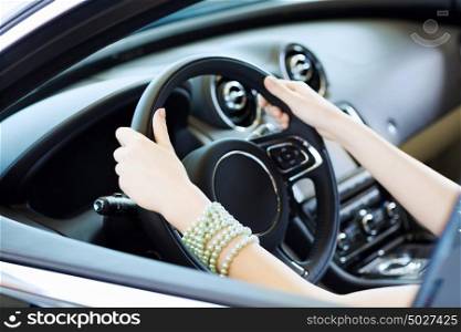 Woman in car. Close up of woman hands driving a car