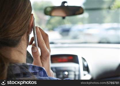 Woman In Car Talking On Mobile Phone Whilst Driving