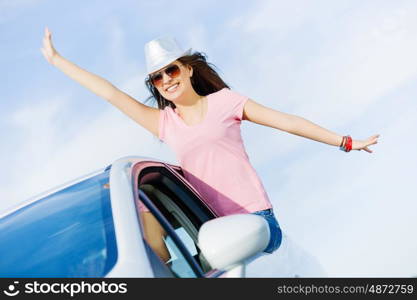 Woman in car. Young pretty woman leaning out of car window