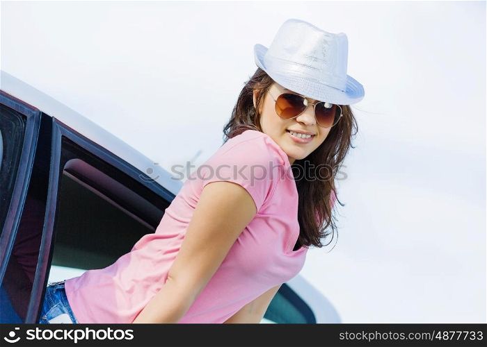 Woman in car. Young pretty woman leaning out of car window