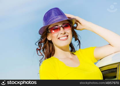 Woman in car. Young pretty woman leaning out of car window