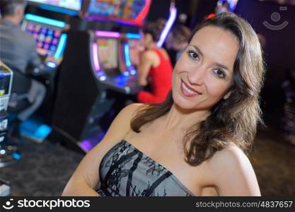 woman in casino next to a slot machine