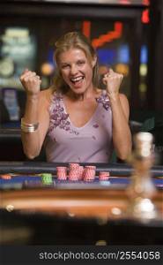 Woman in casino winning roulette smiling (selective focus)