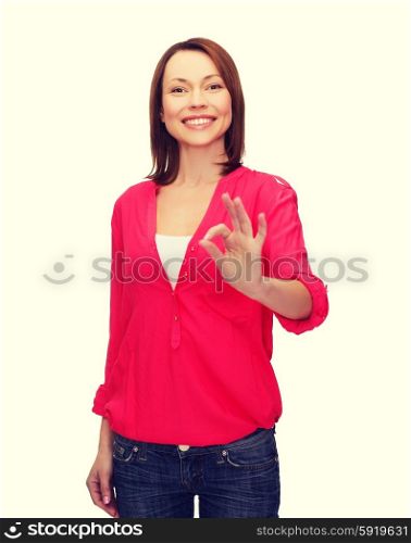 woman in casual clothes showing ok gesture. happy people concept - smiling woman in casual clothes showing ok gesture