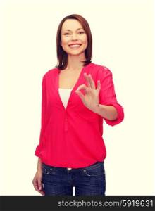 woman in casual clothes showing ok gesture. happy people concept - smiling woman in casual clothes showing ok gesture
