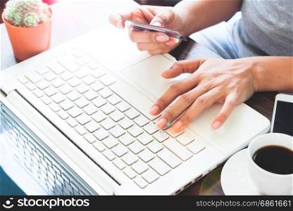 Woman in casual clothing using laptop with credit card, Online shopping at home