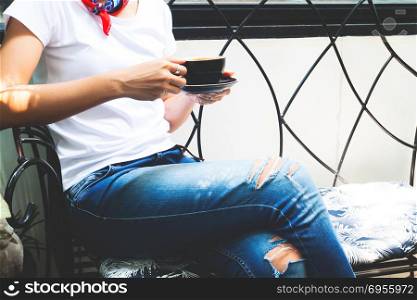 Woman in casual style clothing, White t-shirt and jeans drinking. Woman in casual style clothing, White t-shirt and jeans drinking coffee, Lifestyle woman concept