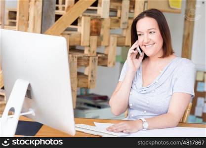 Woman in casual wear with his mobile in office