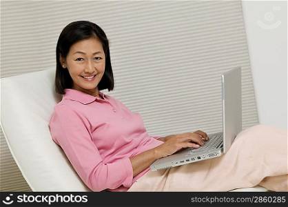 Woman in Chair Using Laptop