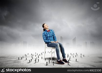 Woman in chair. Woman in casual sitting on chair and many small silhouettes of businesspeople around