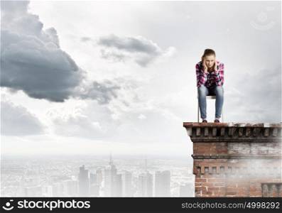 Woman in chair. Young woman in casual sitting on in chair on top of building