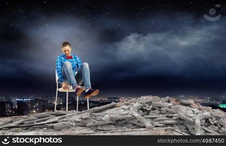 Woman in chair. Young woman sitting in chair on ruins
