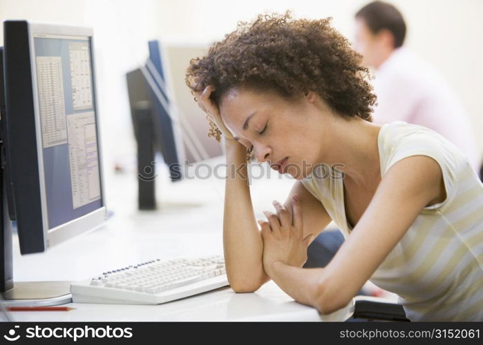 Woman in computer room sleeping