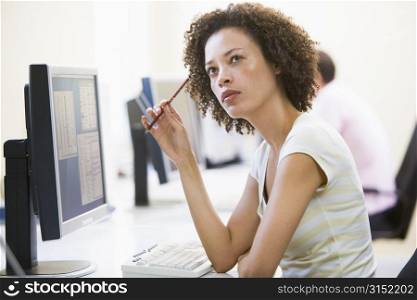 Woman in computer room thinking
