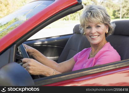 Woman in convertible car smiling