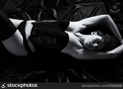 woman in corsage on bed. beautiful sensual woman in corsage on bed from top