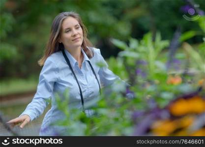 woman in countryside looking over fence