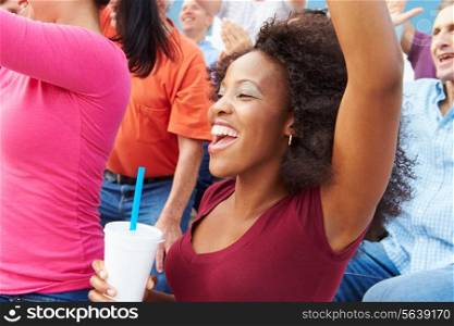 Woman In Crowd Celebrating At Sports Event