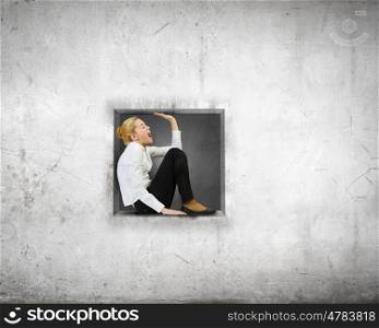 Woman in cube. Young businesswoman trapped in stone cube in wall