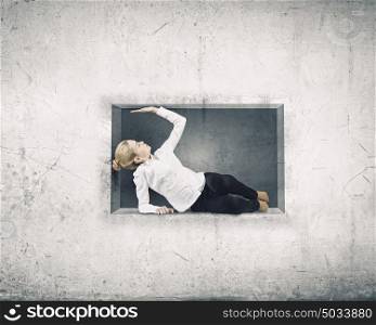 Woman in cube. Young businesswoman trapped in stone cube in wall