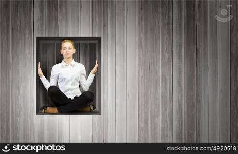 Woman in cube. Young businesswoman trapped in wooden cube in wall