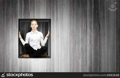 Woman in cube. Young businesswoman trapped in wooden cube in wall