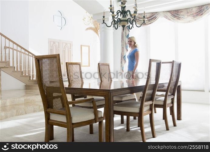 Woman in dining room smiling