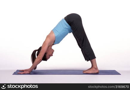 Woman in Downward Dog Pose on Mat