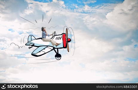 Woman in drawn airplane. Funny image of woman flying in drawn airplane