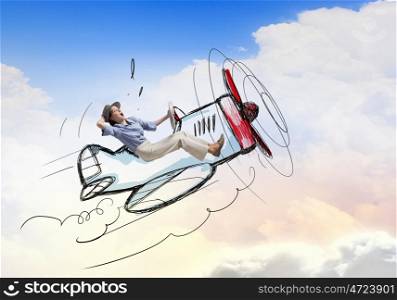 Woman in drawn airplane. Young funny woman flying in air in drawn airplane