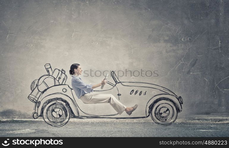 Woman in drawn car. Young humorous woman driving drawn funny car