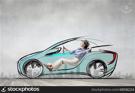 Woman in drawn car. Young humorous woman driving drawn funny car
