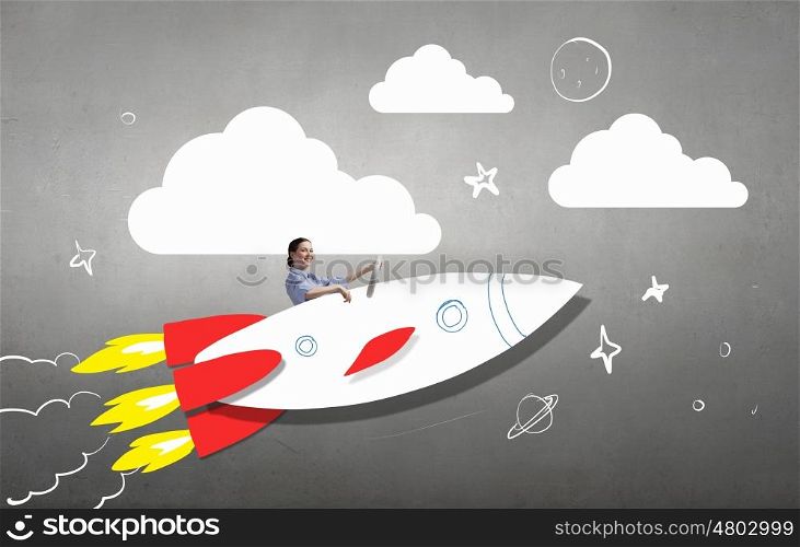 Woman in drawn rocket. Young happy student girl riding fast drawn rocket