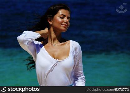 Woman in dress on beach. Woman in white dress posing in tropical sea beach