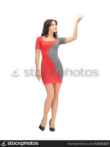 woman in dress showing something above her with her hand