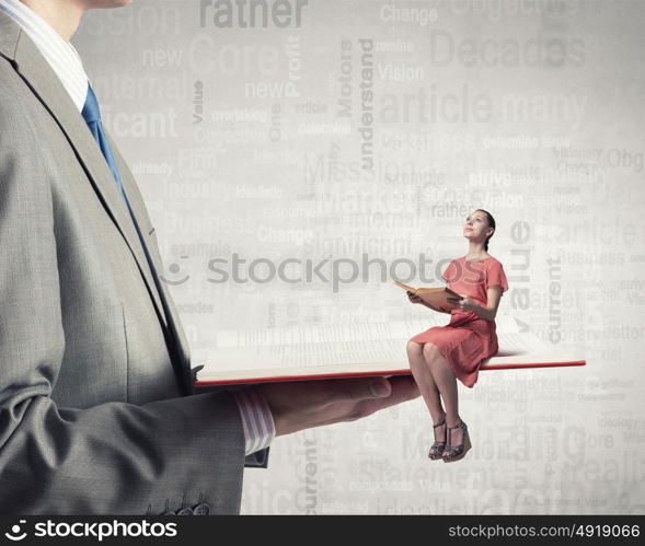Woman in dress with book. Young girl sitting on red opened book and reading