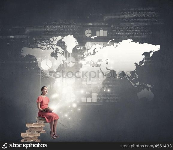 Woman in dress with book. Young girl sitting on stack of books and reading