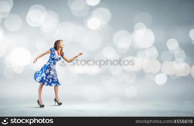 Woman in dress. Young woman in blue dress against bokeh background