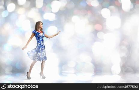 Woman in dress. Young woman in blue dress against bokeh background